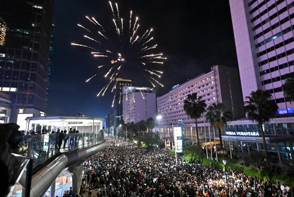 Revelers celebrate the New Year at the Selamat Datang Monument at the Hotel Indonesia roundabout in Jakarta, Indonesia.
Adek Berry/AFP via Getty Images