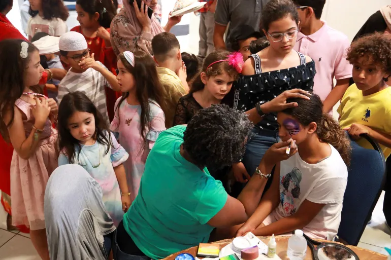Children get their faces painted at the Muslim Community Center during Eid al-Adha celebrations in Louisville, Kentucky, US [File: Amira Karaoud/Reuters]
