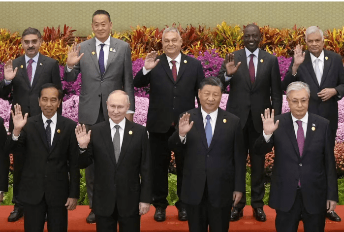 Xi Jinping and Vladimir Putin wave with other leaders as they take part in an international forum on China’s Belt and Road Initiative at the Great Hall of
the People in Beijing last week © Kyodo/Reuters