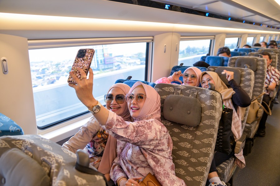Passengers take selfies in a carriage of a high-speed electrical multiple unit (EMU) train running on the Jakarta-Bandung High-Speed Railway in Indonesia, Oct. 17, 2023. (Photo/Xinhua)
