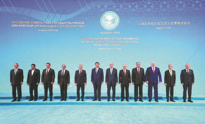 President Xi Jinping poses for a group photo on Thursday with other leaders attending the 24th Meeting of the Council of Heads of State of the Shanghai Cooperation Organization at the Independence Palace in Astana, Kazakhstan.