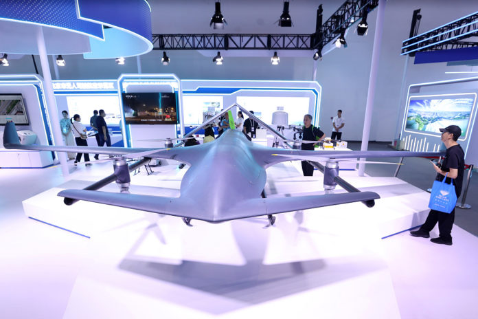 Visitors check out a vertical takeoff and landing drone at the 26th China Beijing International High-tech Expo, July 14, 2024. [Photo/VCG]