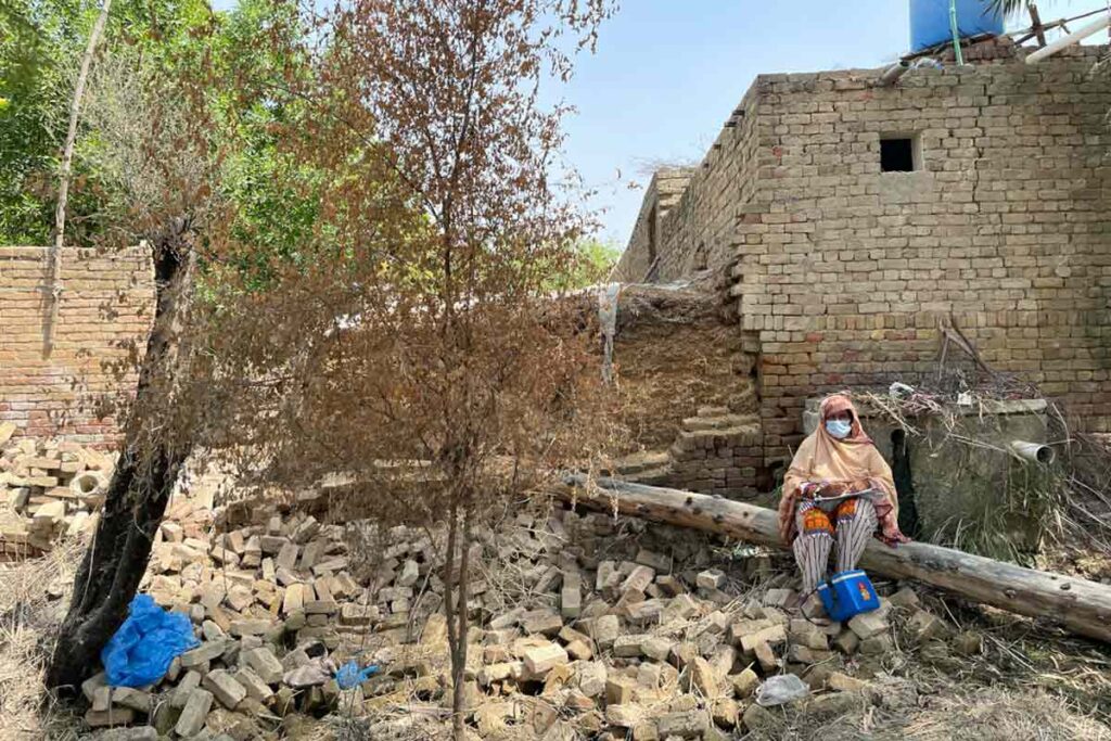 Health worker Shahida Saleem sits outside her house in Fatehpur, Rajanpur district during a polio campaign in September 2022. © WHO/Pakistan
