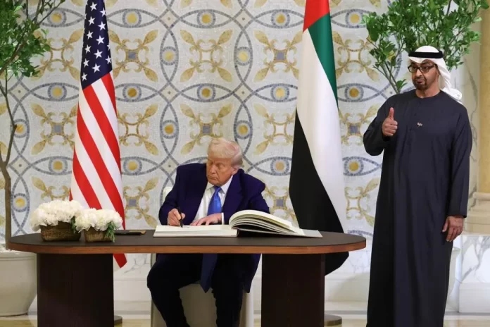 ABU DHABI, UNITED ARAB EMIRATES - MAY 15: U.S. President Donald J. Trump signs the guestbook as UAE President Sheikh Mohamed bin Zayed Al Nahyan looks on and gives a thumbs up gesture after a meeting at Qasr al Watan (Palace of the Nation) on May 15, 2025, in Abu Dhabi, United Arab Emirates. Trump is on the third day of his visit to the Gulf to underscore the strategic partnership between the United States and regional allies including the UAE, focusing on security and economic collaboration. (Photo by Win McNamee/Getty Images) ABU DHABI, UNITED ARAB EMIRATES - MAY 15: U.S. President Donald J. Trump signs the guestbook as UAE President Sheikh Mohamed bin Zayed Al Nahyan looks on and gives a thumbs up gesture after a meeting at Qasr al Watan (Palace of the Nation) on May 15, 2025, in Abu Dhabi, United Arab Emirates. Trump is on the third day of his visit to the Gulf to underscore the strategic partnership between the United States and regional allies including the UAE, focusing on security and economic collaboration. (Photo by Win McNamee/Getty Images)