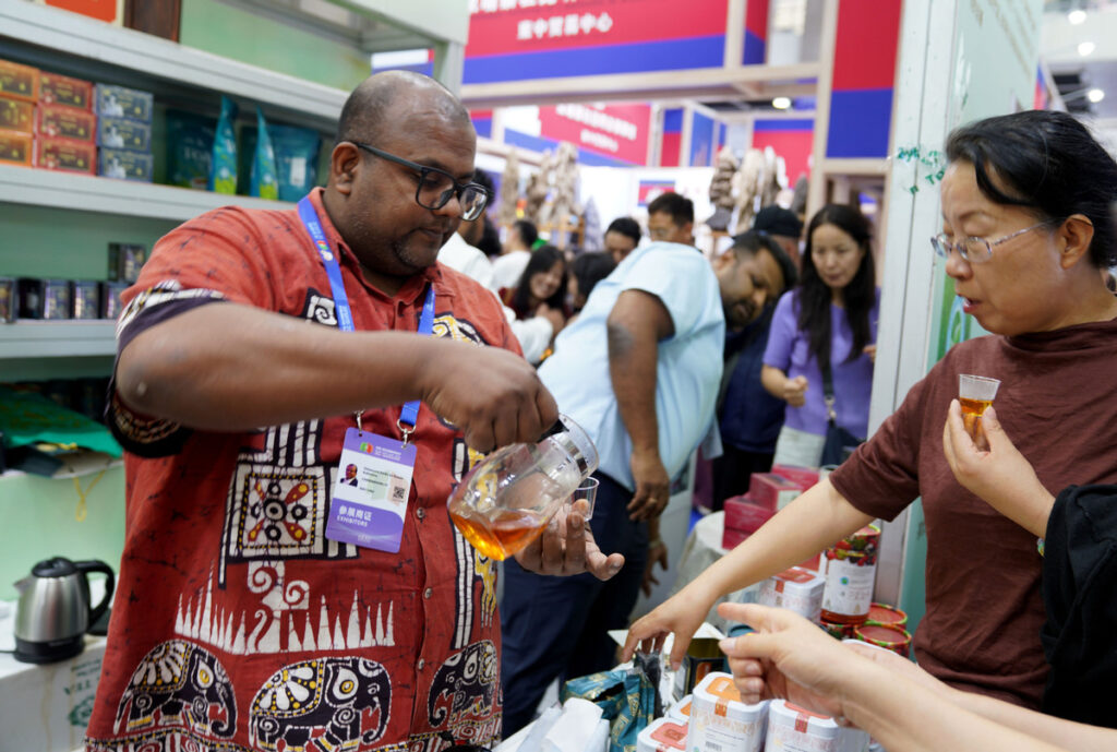 An exhibitor from Sri Lanka introduces tea to visitors at the expo on Aug 30. ZHAO YUSI/XINHUA